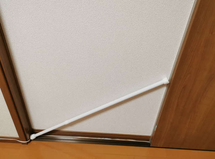 A tension rod wedged against a door so it can't be opened