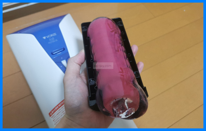 Holding the Mada Namae ga Arimasen onahole in the A10 Piston SA sleeve case