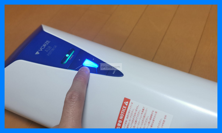 Pressing the A10 Piston SA's mode button, lit blue