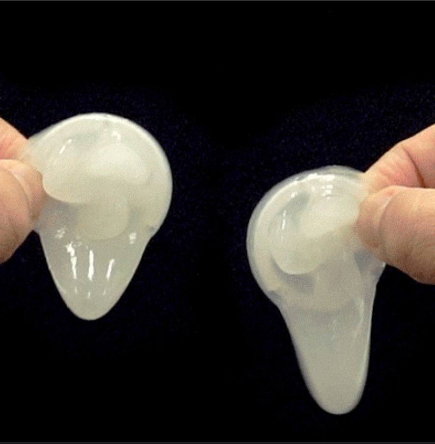 Two soft, translucent gel-type propeller attachments held between fingers