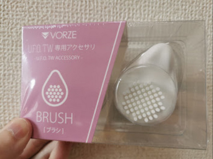The brush attachment that comes with the U.F.O. TW, in its pack