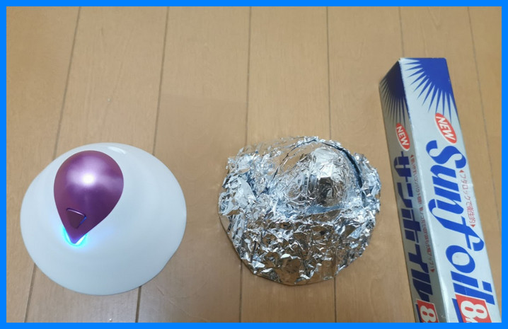 A U.F.O. TW cup next to a cup wrapped in aluminum foil and a box of foil