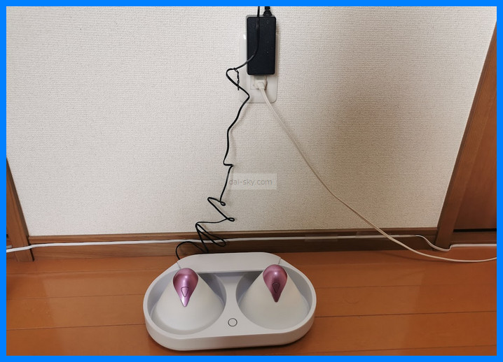 The U.F.O. TW charging in its cradle, plugged into the wall