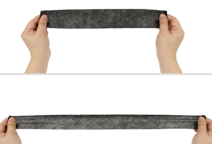 An elastic bandage being stretched between two hands