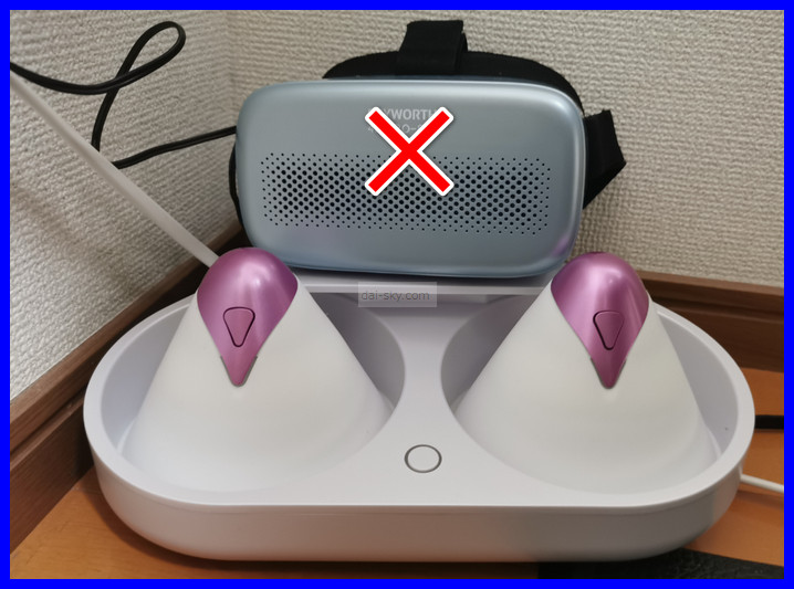 My SKYWORTH VR headset with an X on it, sitting on the U.F.O. TW cradle