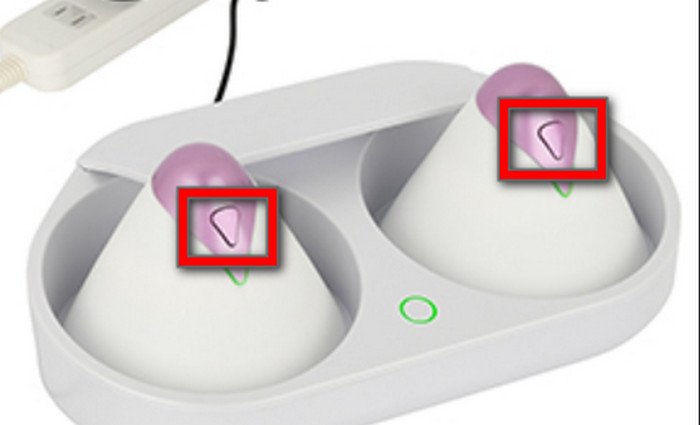 The U.F.O. TW cups in the cradle with their power buttons highlighted